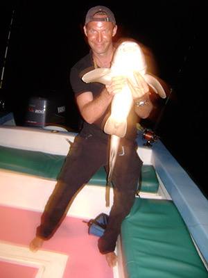 Heavy rod bent against a night catch
