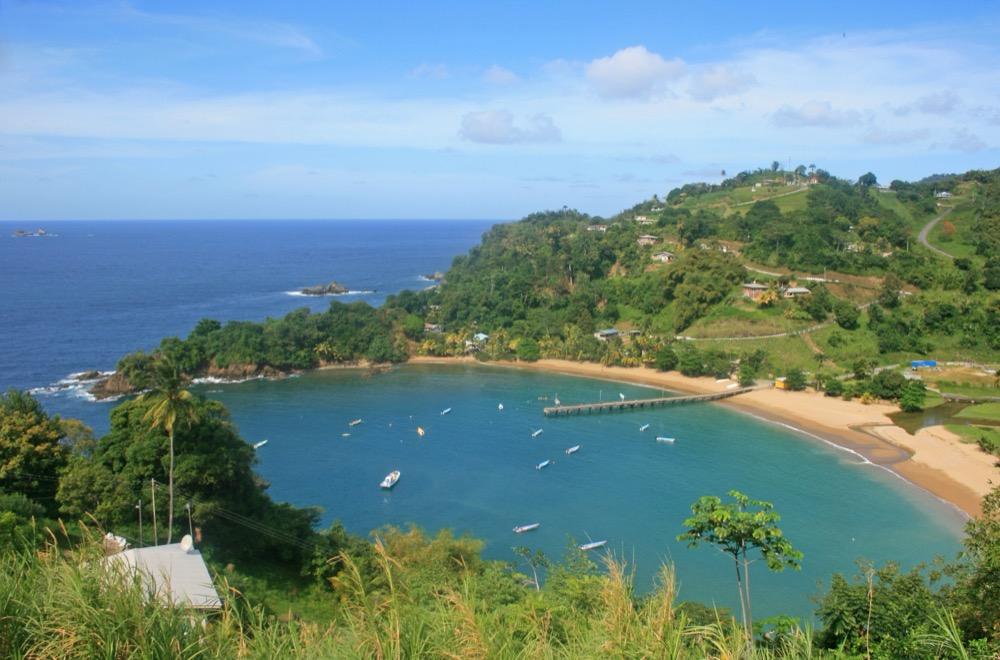 Parlatuvier Bay's curve of sand and jetty from the hill road